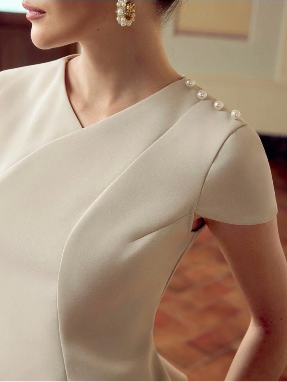 Elegant Cream Peplum Top with Button Shoulder Detail - Picture 2 of 3